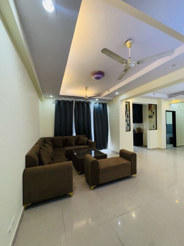 Living room with sofa set, curtains and ceiling lights